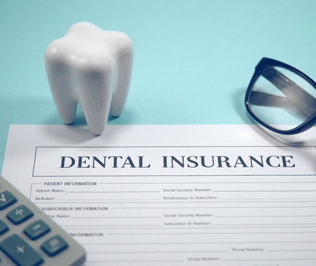 Dental insurance claim form on desk.