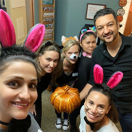 Dentist with team members wearing Halloween costumes