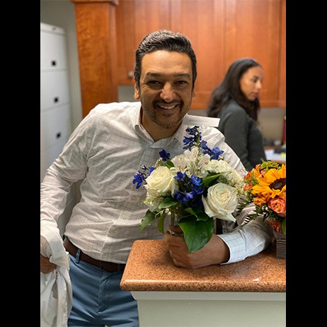 Dentist holding a bouquet of flowers