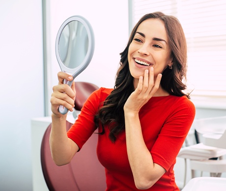 Woman looking at smile in mirror