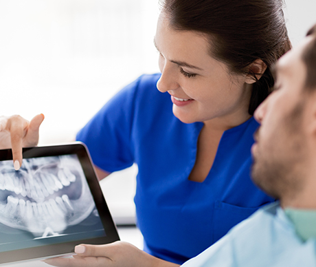 team member showing patient x-rays