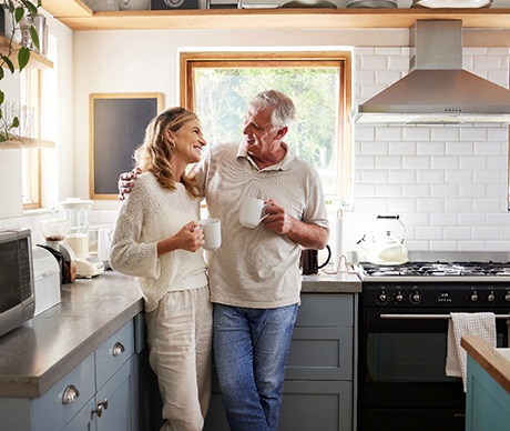 Senior couple drinking coffee in kitchen