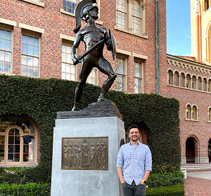 Dr. Saad posing with USC statue