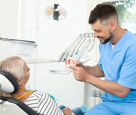 Dentist explaining cost of treating dental emergencies in Vienna to patient