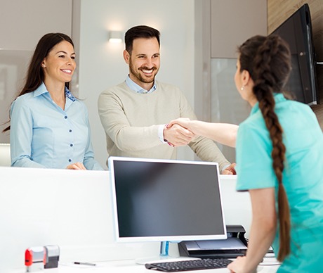 Man and woman checking in at dental office