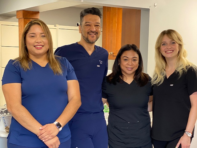 Team members and dentist standing in Vienna dental office