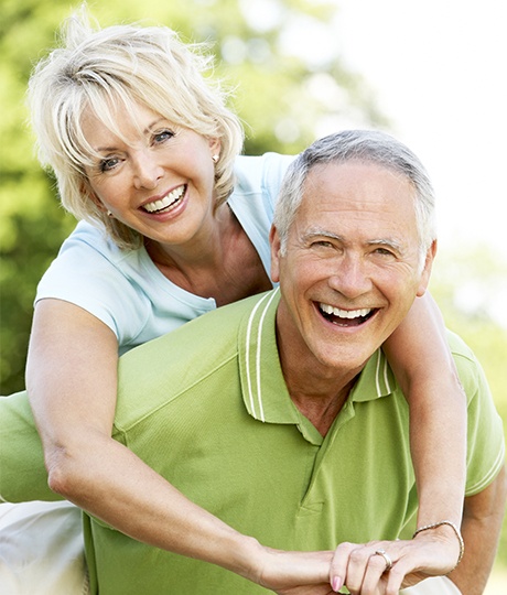 Smiling older man and woman outdoors