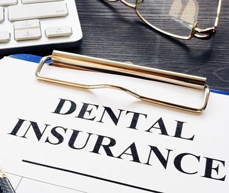 Dental insurance forms on clipboard