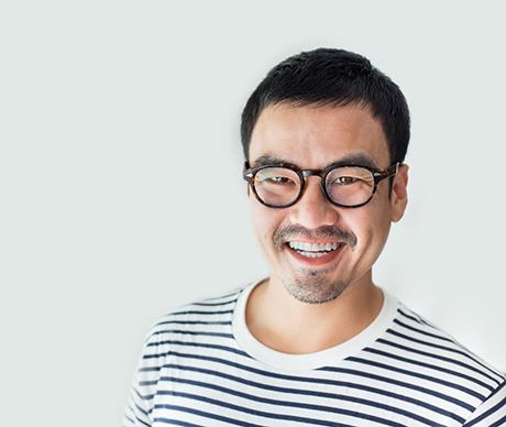 person with glasses smiling