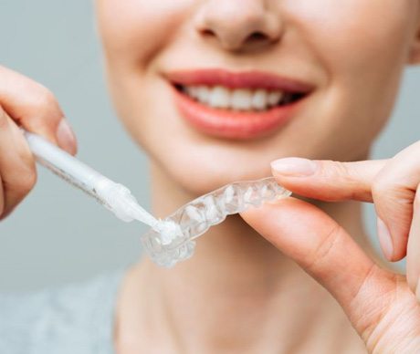 Woman holding custom tooth tray