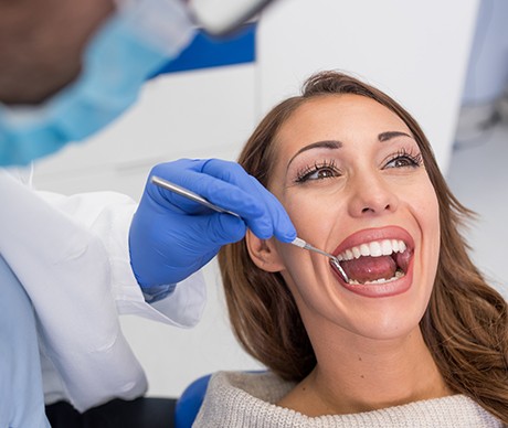 Woman receiving oral cancer screening