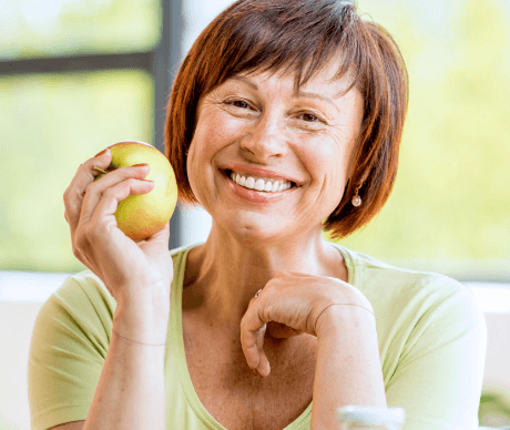 Older woman holding an apple