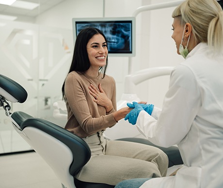 Smiling patient shaking dentist's hand