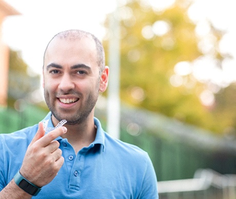 Man in blue shirt enjoying benefits of SureSmile