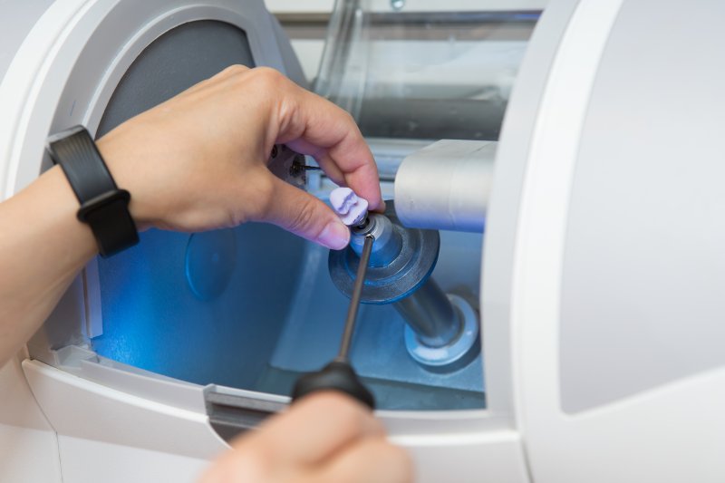 A dentist milling a CEREC crown