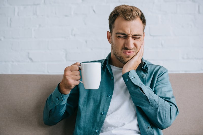 A young man with a toothache or sinus pressure