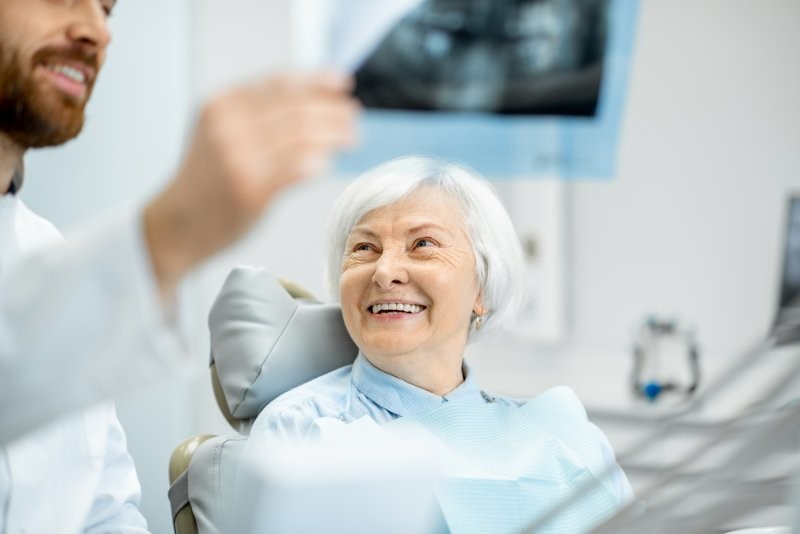 person smiling while talking to dentist