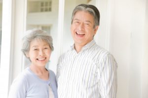 a senior couple showing their healthy smiles