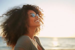 a woman smiling in the summer sun