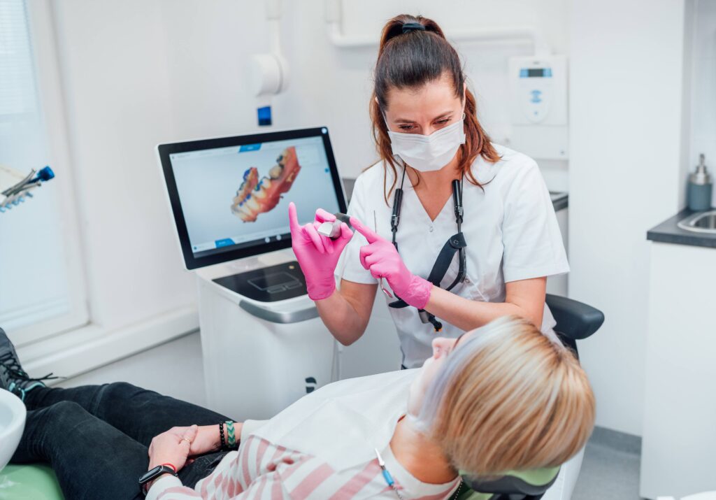 Dentist showing patient clear aligner in treatment room