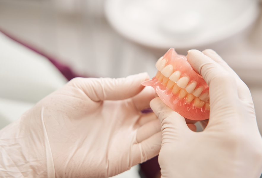 Dentist holding dentures